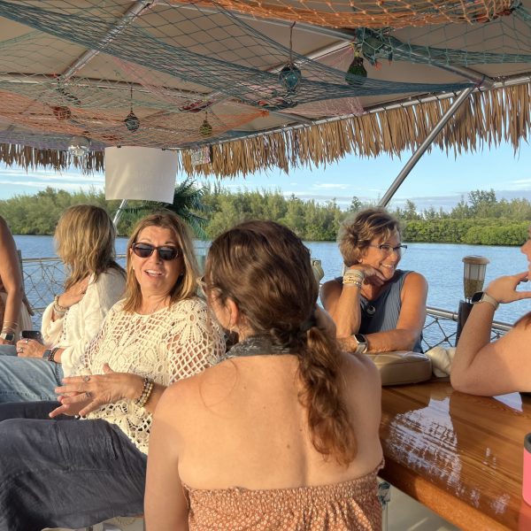 Group of women on a thatched boat having a conversation